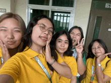 a group of girls posing for a picture in front of a door that says exit