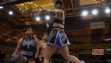 a wrestling match is being played in front of a sign for showboat