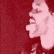 a close up of a man 's face with his tongue hanging out