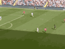 a group of soccer players are playing on a field that says water challenge on the fence