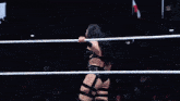 a woman in a wrestling ring with a w on the side