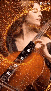 a woman is playing a violin with the word buses on the strings