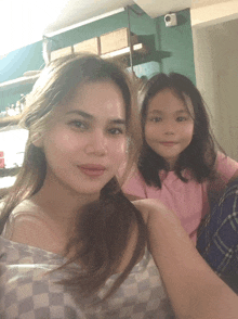 a woman and a little girl posing for a picture