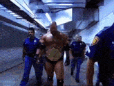 a man in a wrestling outfit is being escorted by police