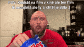 a bald man in a red shirt is eating a bag of mrs. potato chips