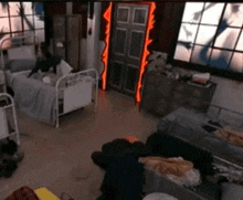 a room with a lot of beds and a door with a red light on it