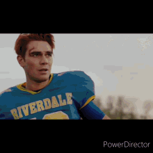a man in a riverdale football jersey looks at the camera