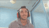 a man wearing headphones and a sweatshirt that says nivea on it