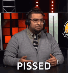 a man wearing headphones says pissed in front of a lightning bolt logo