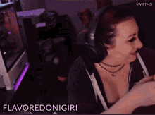 a woman wearing headphones is playing a video game and says flavoredonigiri in the corner