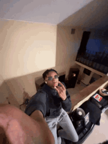 a person wearing sunglasses is taking a picture of themselves