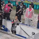 a man wearing a shirt that says 7k is standing in the water
