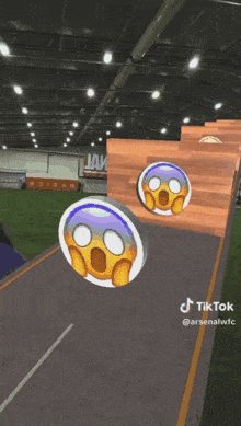 a tiktok video of a surprised emoji on a wooden wall