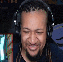 a man wearing headphones is smiling in front of a screen that says " hotdrip "