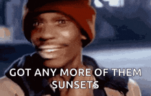 a man wearing a red hat is smiling with the words got any more of them sunsets