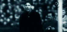 a blurry picture of a soccer player with a soccer ball in the background