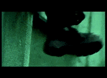 a person 's foot is visible in a green screen