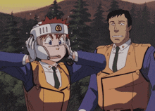a man and a woman are standing next to each other and the woman is wearing a helmet with the letter o on it