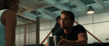 a man and woman are sitting at a table talking