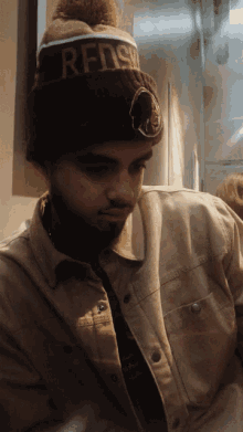 a man wearing a beanie that says redskins on it