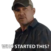 a man wearing a hat and plaid shirt is asking who started this