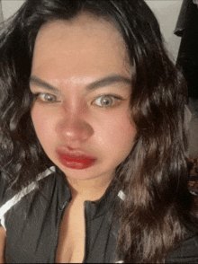 a close up of a woman 's face with red lipstick