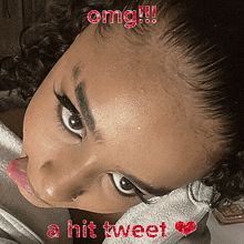 a close up of a woman 's face with the words omg !!! a hit tweet below it