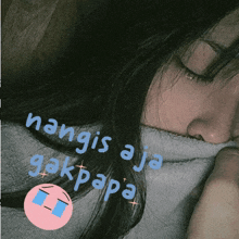 a woman with her eyes closed has a sticker on her face that says hangis aja