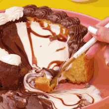 a person is taking a bite out of a chocolate cake with whipped cream