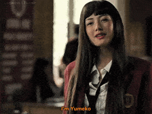 a woman in a red jacket and tie says i 'm yumeko
