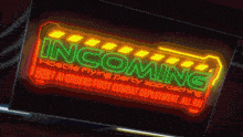 a neon sign that says incoming on it