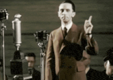 a man in a suit giving the middle finger