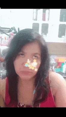 a woman with a sticker on her nose that says ' a ' on it