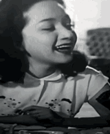a black and white photo of a woman with her eyes closed