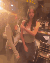 two women are standing next to each other and one has a name tag that says ' iii ' on it