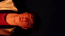 a man is laying upside down and making a funny face .