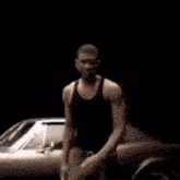 a man is dancing in front of a car .