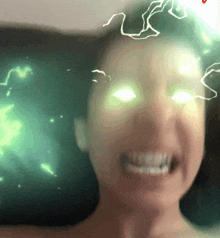 a close up of a woman 's face with green lightning bolts coming out of her eyes