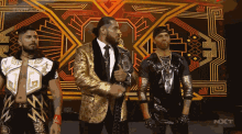 three men standing in front of a screen that says nxt on it