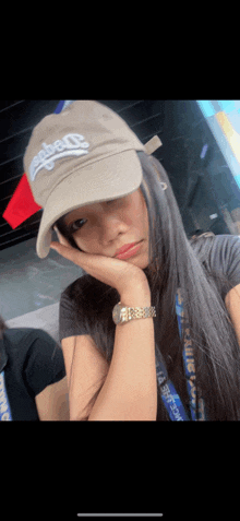 a woman wearing a hat that says ' la ' on it is taking a selfie
