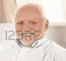 an elderly man with a beard is wearing a scarf and a sweater .
