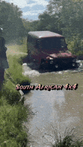 a south african 4x4 driving through a muddy stream