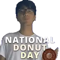 a man wearing glasses is holding a donut in front of a banner that says national donut day