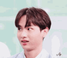 a close up of a young man making a funny face