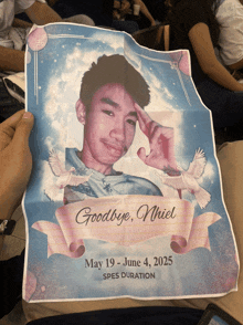a person holding a piece of paper that says goodbye nhiel on it