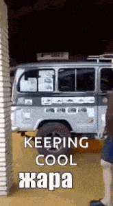a man standing next to a van that says keeping cool hapa