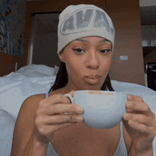 a woman wearing a beanie that says awa on it