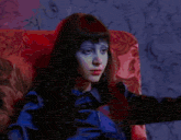 a woman sits in a chair in front of a ghost