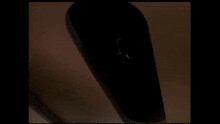 a black coffin is sitting on a wooden table .