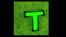 a green letter t is glowing in the dark on a green background
